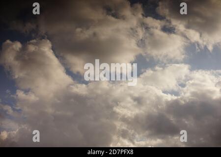 Autumnal blue sky with grey clouds in sunny day Stock Photo