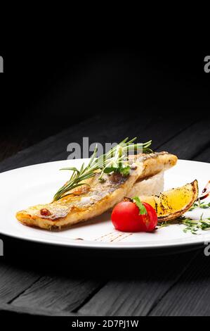 Grilled fish with black rice Stock Photo - Alamy
