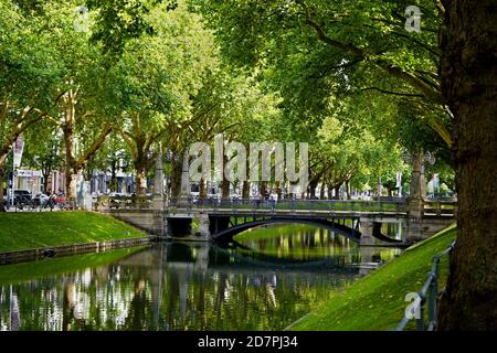 The beautiful historic city canal 'Kö-Graben' on Königsallee in Düsseldorf with old trees and bridges. Stock Photo