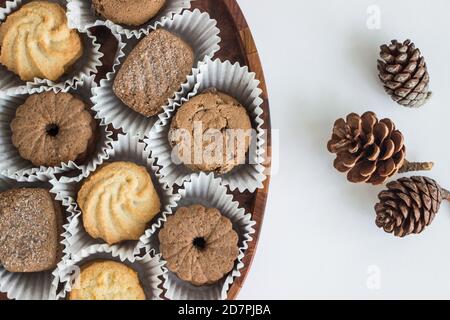 homemade biscuits in wooden plate on white table Stock Photo