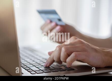 Hands holding credit card and using laptop. Online shopping Stock Photo