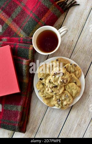 Fresh warm homemade cookies to relax and enjoy with tea and good book on cold winter afternoons lockdown at home Stock Photo