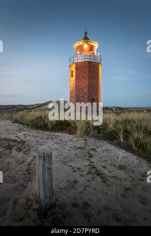 Cross light, lighthouse with sand dune in the evening light, Kampen, Sylt, Germany Stock Photo