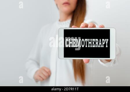 Conceptual hand writing showing Chemotherapy. Concept meaning the treatment of disease by the use of chemical substances Model displaying black screen Stock Photo