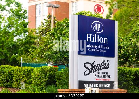 Gainesville, USA - April 27, 2018: Sign for entrance to Hilton hotel conference center and Shula's steakhouse restaurant at campus of UF University of Stock Photo