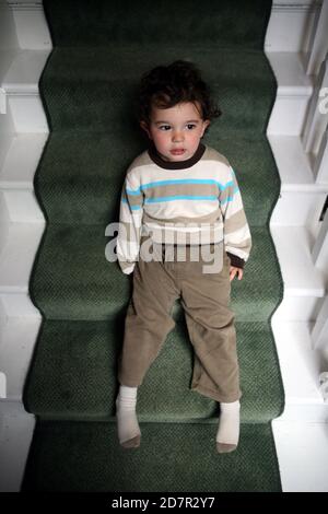 Male toddler on naughty step Stock Photo