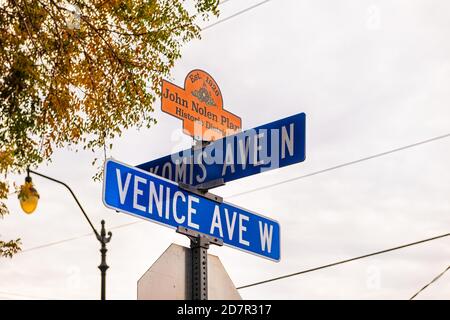 Venice, USA - April 29, 2018: Sign post in small Florida city town in gulf of Mexico with cloudy sky and text for west avenue historic district John N Stock Photo