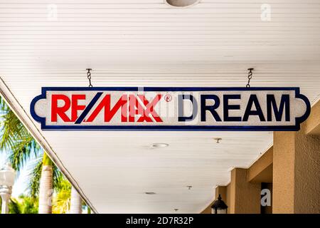 Fort Myers, USA - April 29, 2018: City town in Florida gulf of mexico coast with shopping street and closeup of sign for remax dream real estate offic Stock Photo