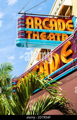 Fort Myers, USA - April 29, 2018: City street during sunny day in Florida gulf of mexico coast with retro vintage sign for Arcade theatre Stock Photo