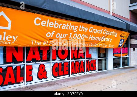 Sterling, USA - September 12, 2020: Ashley homestore sign by entrance of store in Fairfax county, Virginia with banner for grand opening clearance sal Stock Photo