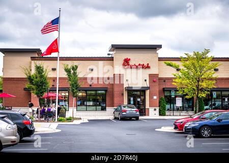 Sterling, USA - September 12, 2020: Chick-fil-a store restaurant fast food shop in northern Virginia with cars in parking lot of building exterior Stock Photo