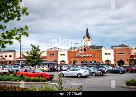 Sterling, USA - September 12, 2020: Wegmans grocery store by parking lot with tower architecture and many cars in northern Virginia Stock Photo