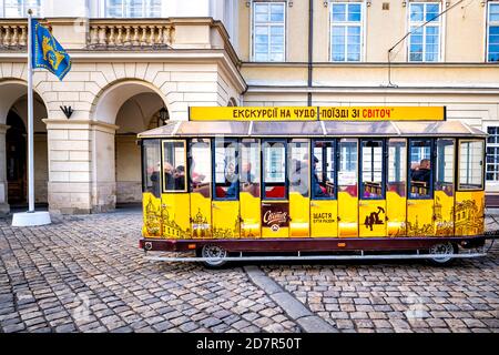 Lviv, Ukraine - January 21, 2020: Ukrainian Lvov city in old town with people sitting inside car of Svitoch sponsored guided tram tramway car tour at Stock Photo