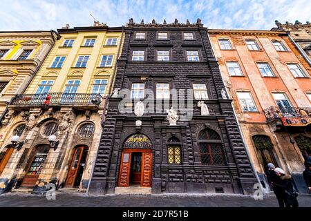 Lviv, Ukraine - January 21, 2020: Ukrainian Lvov city in old town with people by Black House museum entrance sign in winter at rynok market square str Stock Photo