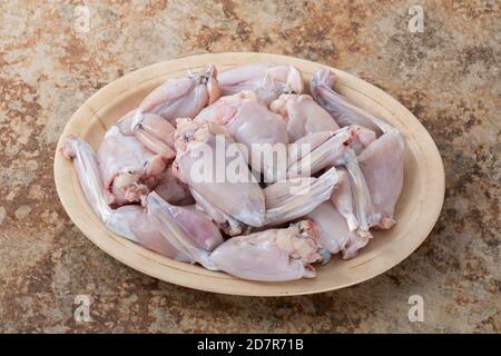 Raw frog legs on a plate Stock Photo - Alamy