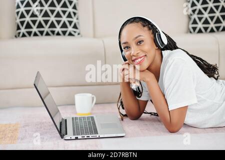 Smiling woman studying at home Stock Photo