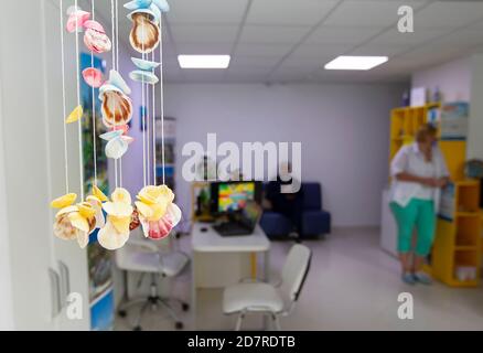 Multicolored seashells on blurred tourist office background Stock Photo