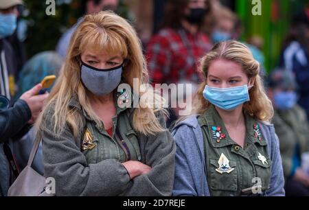 Fans wear masks while walking in the gift shop before a baseball