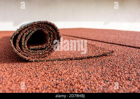 Bitumen roll shingles are laid on the roof on which a roll of shingles lies Stock Photo