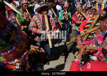 El Alto, Bolivia. 24th Oct, 2020. Musicians play wind instruments during a celebration of the Movement Towards Socialism (MAS) party for the results in the general elections, in El Alto, Bolivia, on Oct. 24, 2020. The main challenge for the new Bolivian government headed by Luis Arce Catacora from the Movement Towards Socialism (MAS) party lies in reviving the country's economy, economists and political experts have said. Credit: Mateo Romay/Xinhua/Alamy Live News Stock Photo