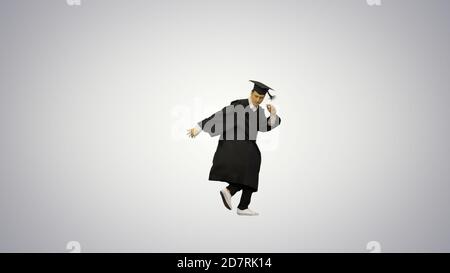 Male graduate in robe and mortarboard doing modern dance and bre Stock Photo