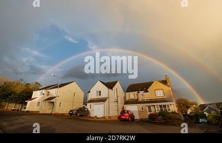 Double rainbow over 3 houses on an estate in Cornwall Stock Photo