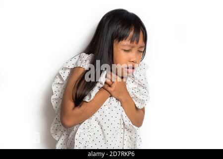 Asian Little girl with sore throat touching her neck.Sore throat sick.Little girl having pain in her throat Stock Photo