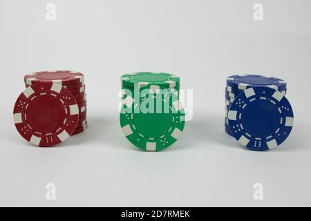 Red green and blue poker chip stacks with one chip for every color leaning on the stack Stock Photo