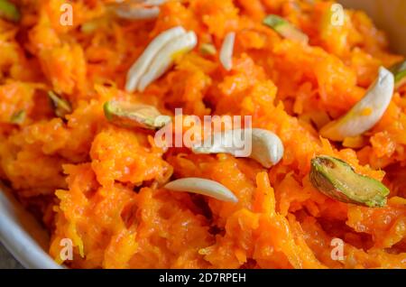 Beautiful Carrot Halwa Background with cashew nuts & pistachio spread over. Stock Photo