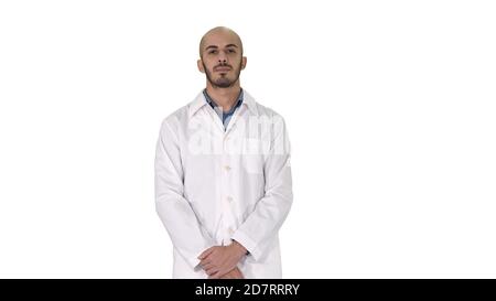 Standing young serious arab doctor on white background. Stock Photo