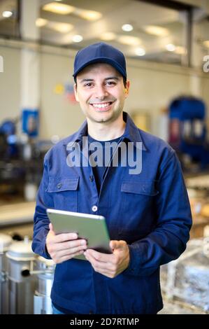 Portrait af an engineer using a tablet in a facility Stock Photo