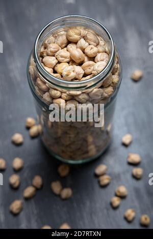 Glass jar with chickpeas placed on a tabletop. Eco friendly concept Stock Photo