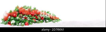 Christmas Decoration with Fir Branches on Snow isolated on white Background - Panorama Stock Photo