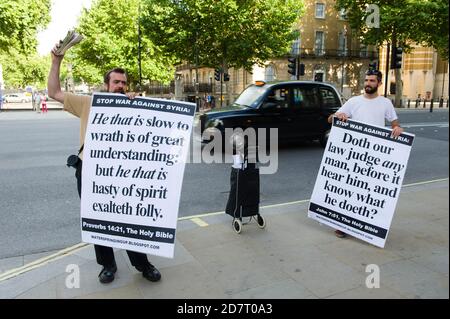 Protesters against Britain taking military action against Syria, after last weeks chemical attacks in Syria by the Syrian regime, outside Downing Street, during a parliamentary debate about what action Britain should take against Syria, Downing Street, Westminster, London, UK.  29 Aug 2013 Stock Photo