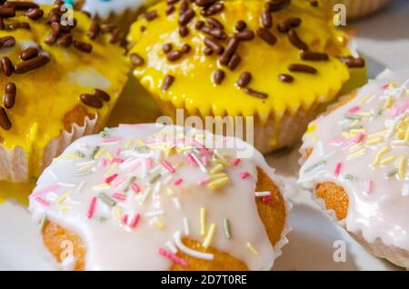 Closeup view of homemade cupcakes decorated with sugar frosting and hundreds and thousands. Stock Photo