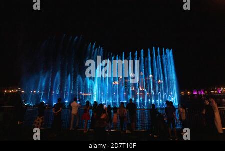 Dubai. 25th Oct, 2020. People enjoy the Palm Fountain show on Palm Jumeirah in Dubai, United Arab Emirates, Oct. 24, 2020. The fountain spreads over 14,000 square feet of sea water and features over 3,000 LED lights in multiple colors. Credit: Xinhua/Alamy Live News Stock Photo