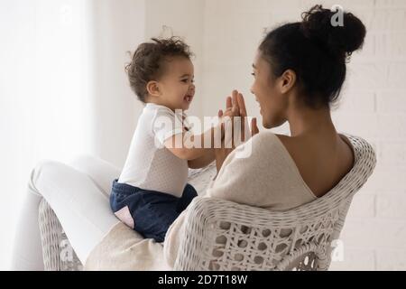 Happy biracial mother play with toddler baby Stock Photo