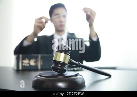 Judge gavel with Justice lawyer, Businessman in suit or lawyer, Advice and Legal services Concept. Chinese character 'beobjeon' means code of laws,law Stock Photo