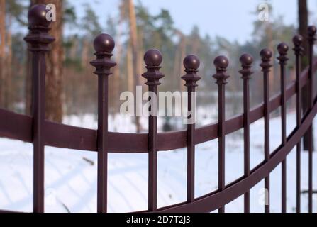 Beautiful wrought fence. Image of a decorative cast iron fence. metal fence close up. Metal Forged Fence. Stock Photo