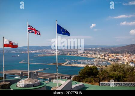 Gibraltar, United Kingdom, 1st October 2018:- View from the top of the Rock of Gibraltar looking North into Spain, with the flags of Gibraltar, UK and Stock Photo
