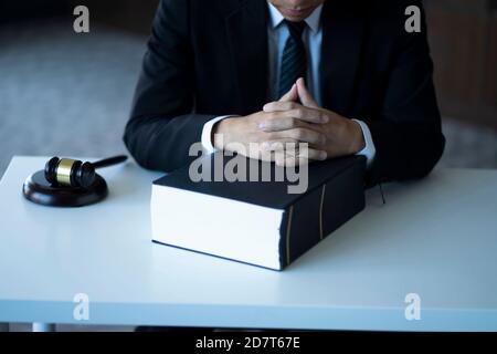 Serious pensive lawyer working at desk in office Stock Photo