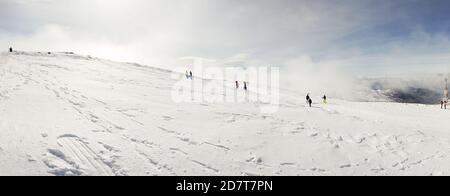 People having fun in snowed mountains in Sierra Nevada Stock Photo