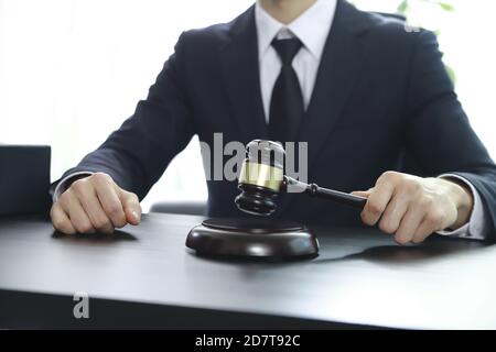 Justice lawyer holding judge gavel, Businessman in suit or lawyer, Advice and Legal services Concept. Stock Photo