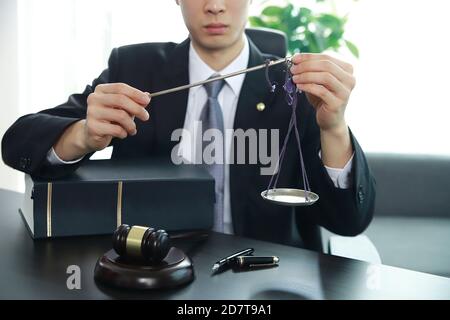 Close up of lawyer holding justice scale. Stock Photo