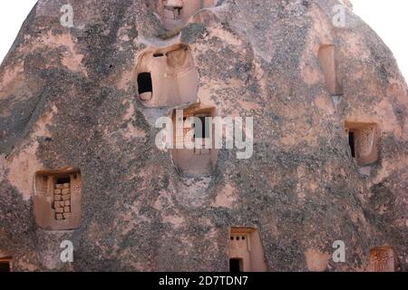 Cave dwellings carved in rock formations. Stock Photo