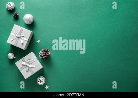 Christmas composition. Christmas decor, gift boxes on multilayer green background. Top view, copy space. Stock Photo