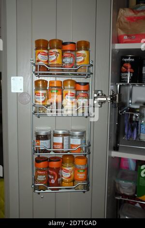 Kitchen cupboard spice rack with a wide range of spices Stock Photo
