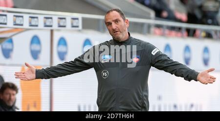 Heidenheim, Germany. 25th Oct, 2020. Football: 2nd Bundesliga, 1st FC Heidenheim - VfL Osnabrück, 5th matchday in the Voith Arena. Coach Frank Schmidt (Heidenheim) spreads his arms. Credit: Stefan Puchner/dpa - IMPORTANT NOTE: In accordance with the regulations of the DFL Deutsche Fußball Liga and the DFB Deutscher Fußball-Bund, it is prohibited to exploit or have exploited in the stadium and/or from the game taken photographs in the form of sequence images and/or video-like photo series./dpa/Alamy Live News