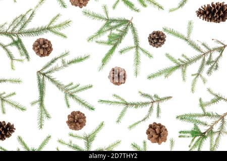 Christmas pattern with fir branches and pine cones on white background. Flat lay, top view Stock Photo