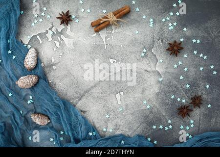 Christmas frame concept made of snowflakes, cinnamon and pine cones on dark. Flat lay. Top view. Winter holiday composition Stock Photo
